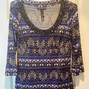 Inc blue multi colored shirt with black sequin rimmed neck.